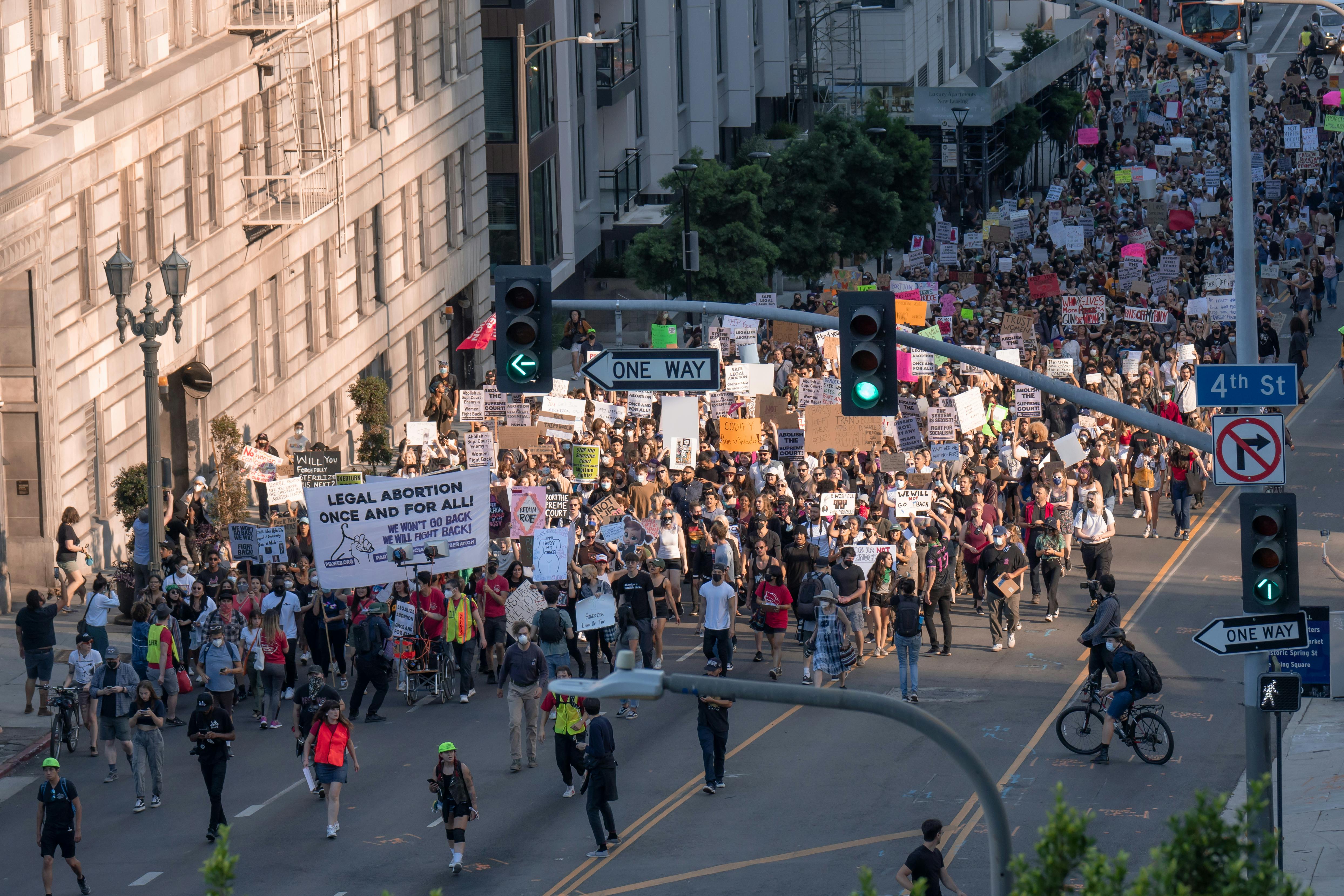A picture of a protest with abortion related signs.